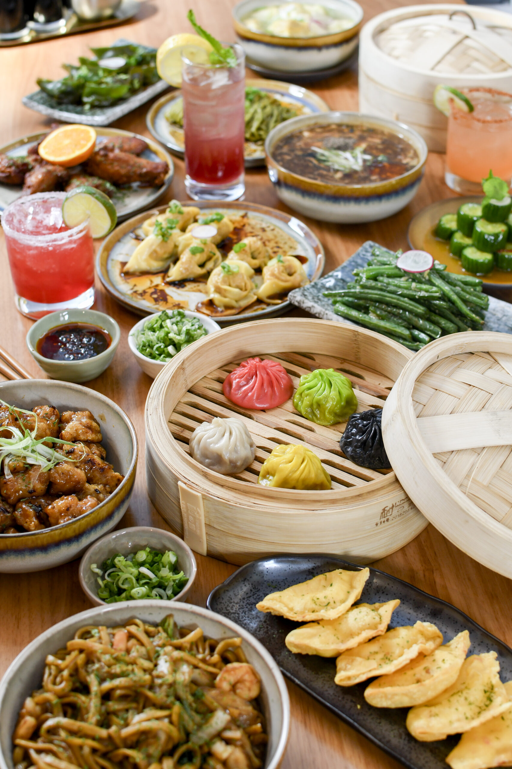 Ugly Dumpling Food featuring XLB, wings, wontons, drinks, green beans, and hot and sour soup